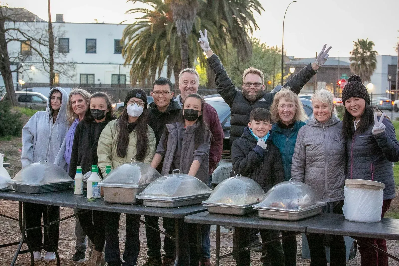 A group of Street Life Ministries volunteers standing behind the serving table before a meal service